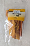 A clear plastic bag containing rolled slices of dried or cured meat, with a yellow label reading 'CHEEK ROLL SLICES 8oz'.